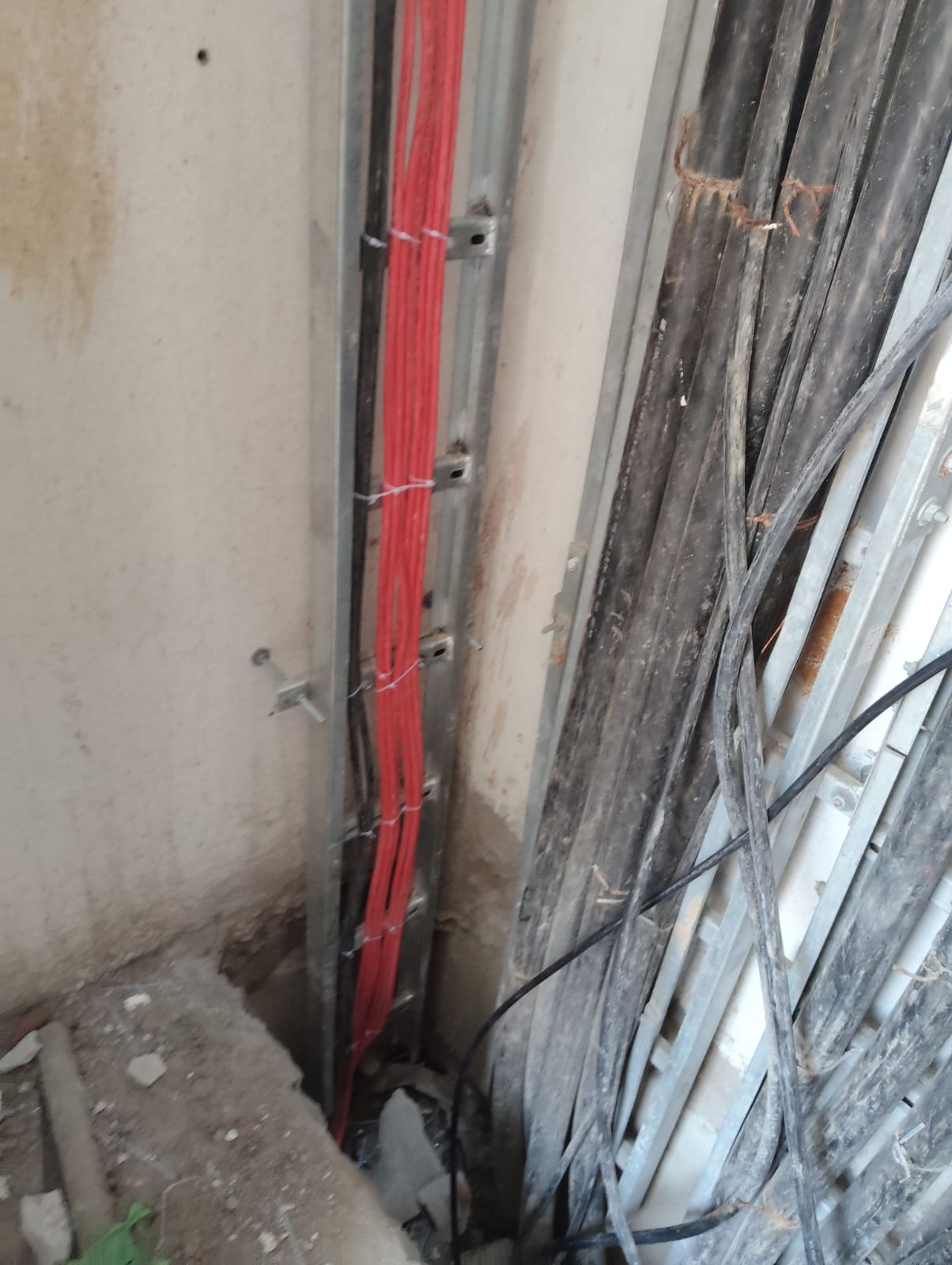 Technician installing fire safety cabling and sprinkler piping on ceiling infrastructure