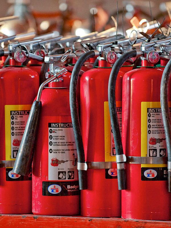 Fire safety technician inspecting fire extinguishers